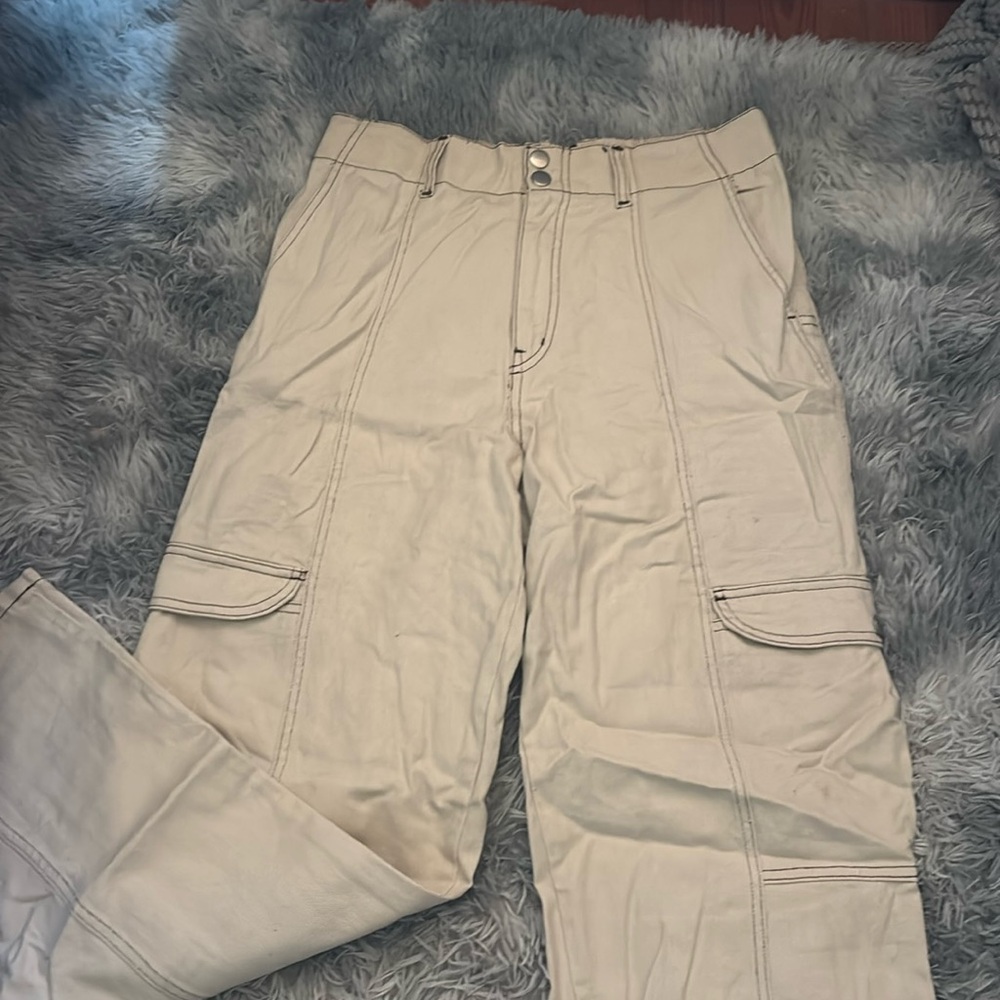 cream colored cargo pants with brown stitching